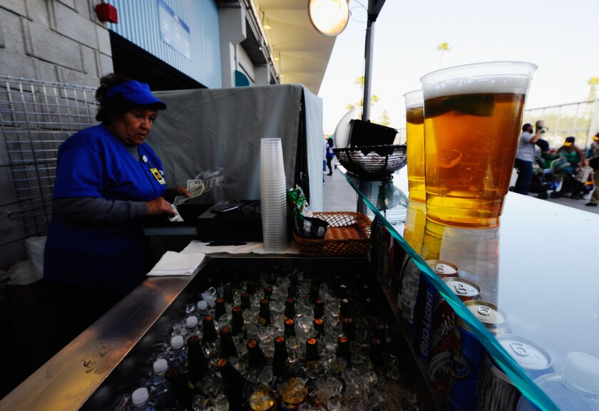A cashier calls a beer purchase at Dodger Stadium.