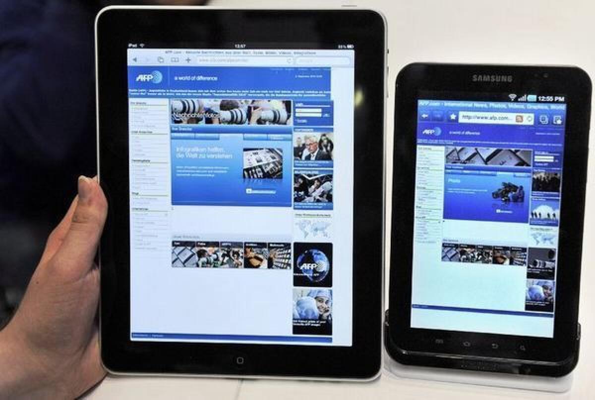 On the left, an Apple iPad from 2010. On the right, Samsung's Galaxy tablet.