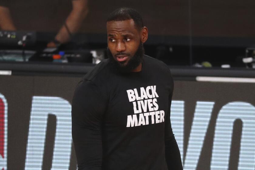 Los Angeles Lakers forward LeBron James looks on before Game 4 of an NBA basketball first-round playoff series.