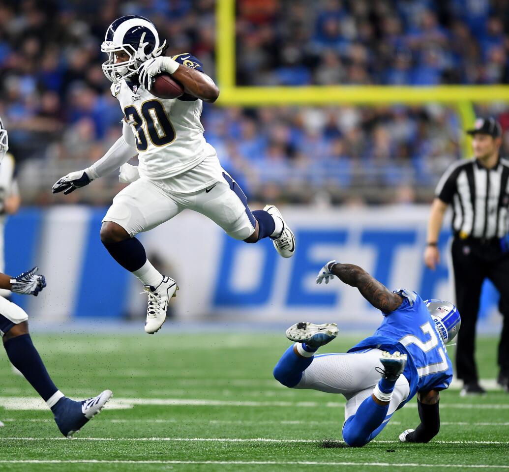 Rams running back Todd Gurley leaps over Detroit Lions safety Glover Quinn in the second quarter at Ford Field in Detroit on Sunday.