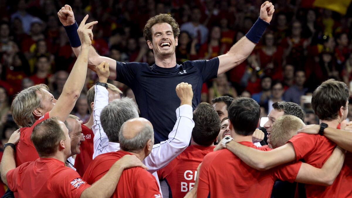 Britain's Andy Murray celebrates with teammates after defeating Belgium's David Goffin to clinch the Davis Cup victory.