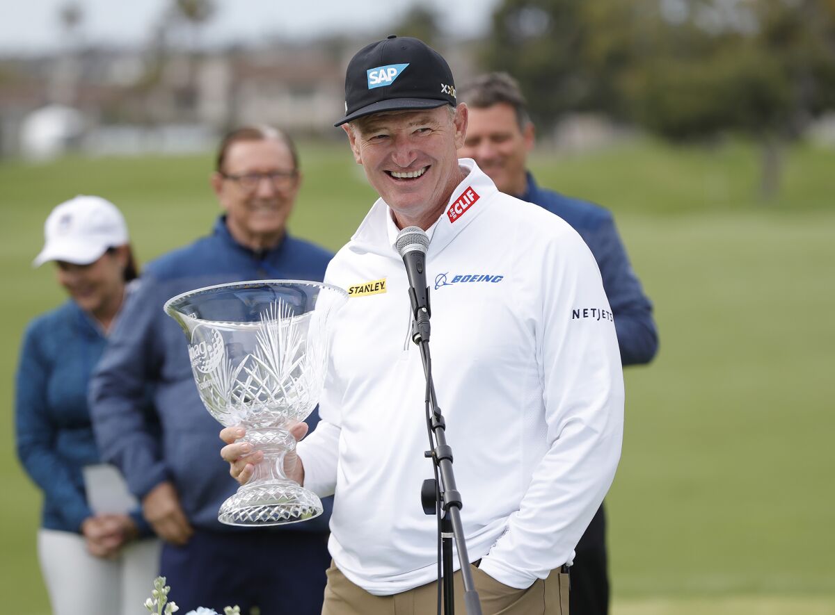 Ernie Els smiles as he holds the Hoag Classic trophy after winning the tournament at Newport Beach Country Club on Sunday.