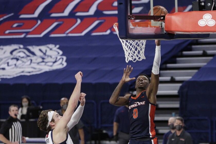 Pepperdine guard Sedrick Altman shoots next to Gonzaga forward Corey Kispert.