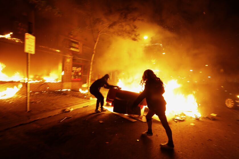 MINNEAPOLIS, Minnesota -MAY 29, 2020-Despite a curfew, protests and looting went all throughout the night in various parts of the city of Minneapolis on Friday night, May 29, 2020. . There were too many fires for firemen to put out on Friday night, May 29, 2020. Protesting continues for a third day in response to the death of George Floyd. (Carolyn Cole/Los Angeles Times