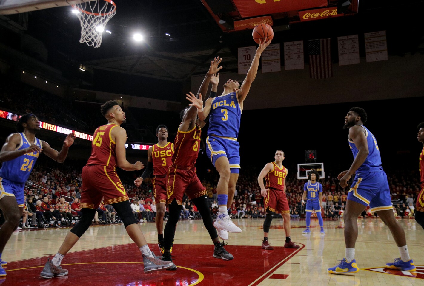 LOS ANGELES, CA - MARCH 7, 2020: UCLA Bruins guard Jules Bernard (3) drives to the basket against USC Trojans forward Onyeka Okongwu (21) in the first half at Galen Center on March 7, 2020 in Los Angeles, California. (Gina Ferazzi/Los AngelesTimes)