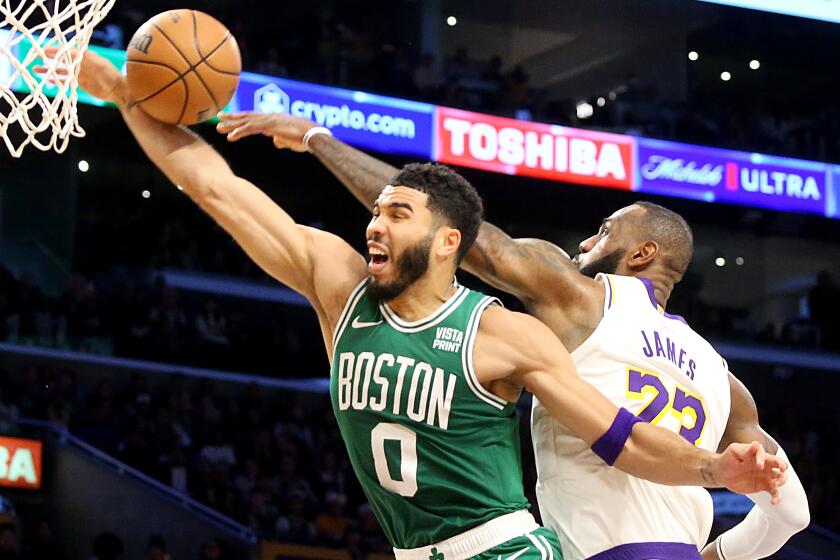 Los Angeles, CA - Lakers forward Lebron James blocks a dunk attampt by Celtics forward Jayson Tatum (0) in the second quarter at Crypto.com Arena in Los Angeles on Christmas Day, Dec. 25, 2023. (Luis Sinco / Los Angeles Times)
