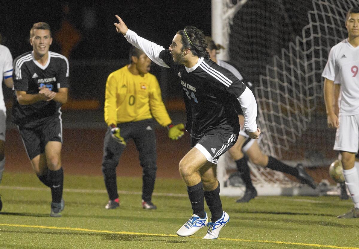 Corona del Mar High's Will Hunter, center, reacts after scoring a goal against Estancia in a nonleague game on Wednesday at Jim Scott Stadium.