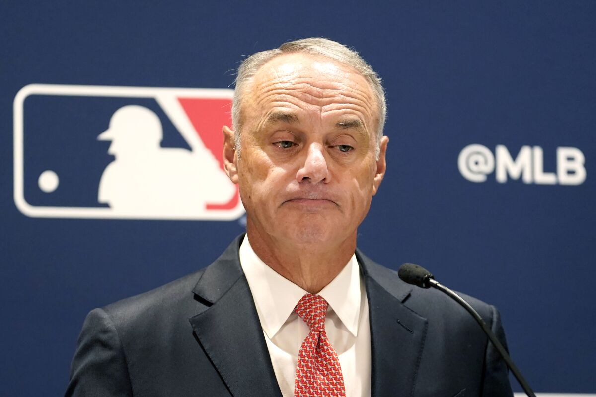 Major League Baseball commissioner Rob Manfred listens to a question 