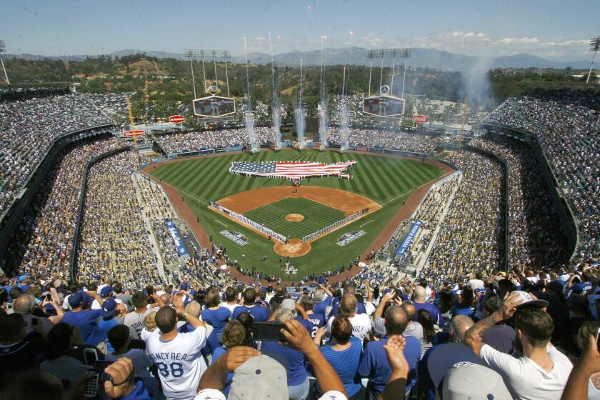 Fans cheer during opening day ceremonies before the start of Monday's game between the Dodgers and San Diego Padres at Dodger Stadium.