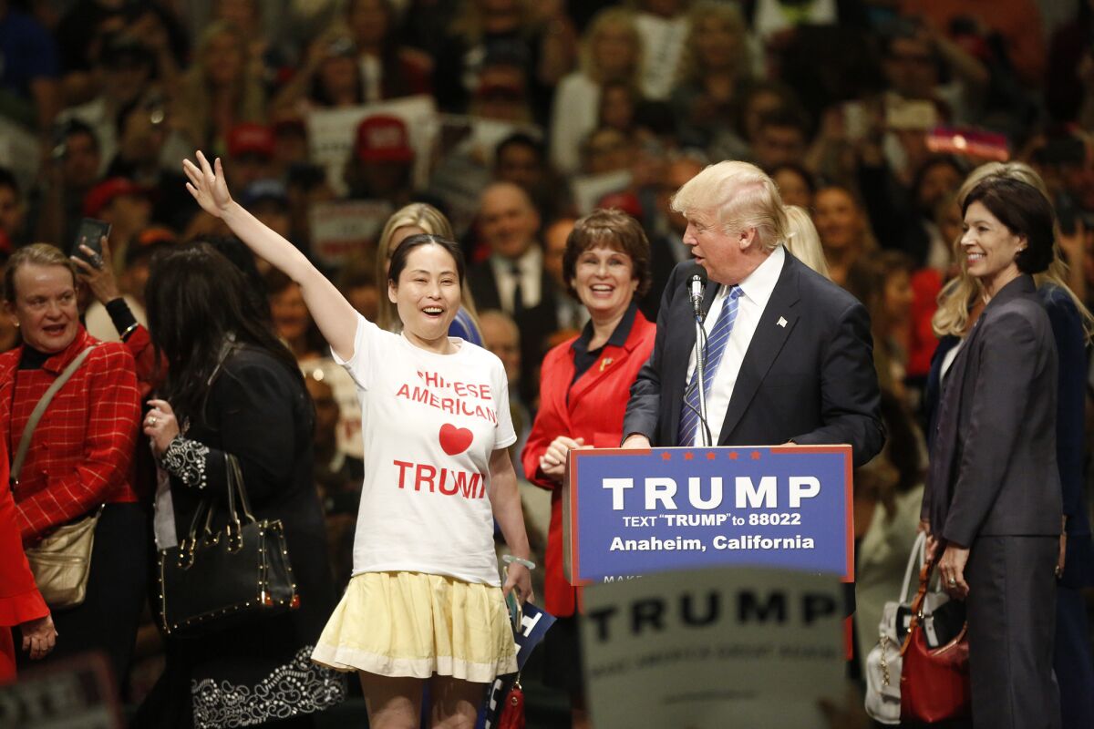 Ling Zeng, a Chinese American Trump supporter takes the stage with the Republican candidate Wednesday at the Anaheim Convention Center.