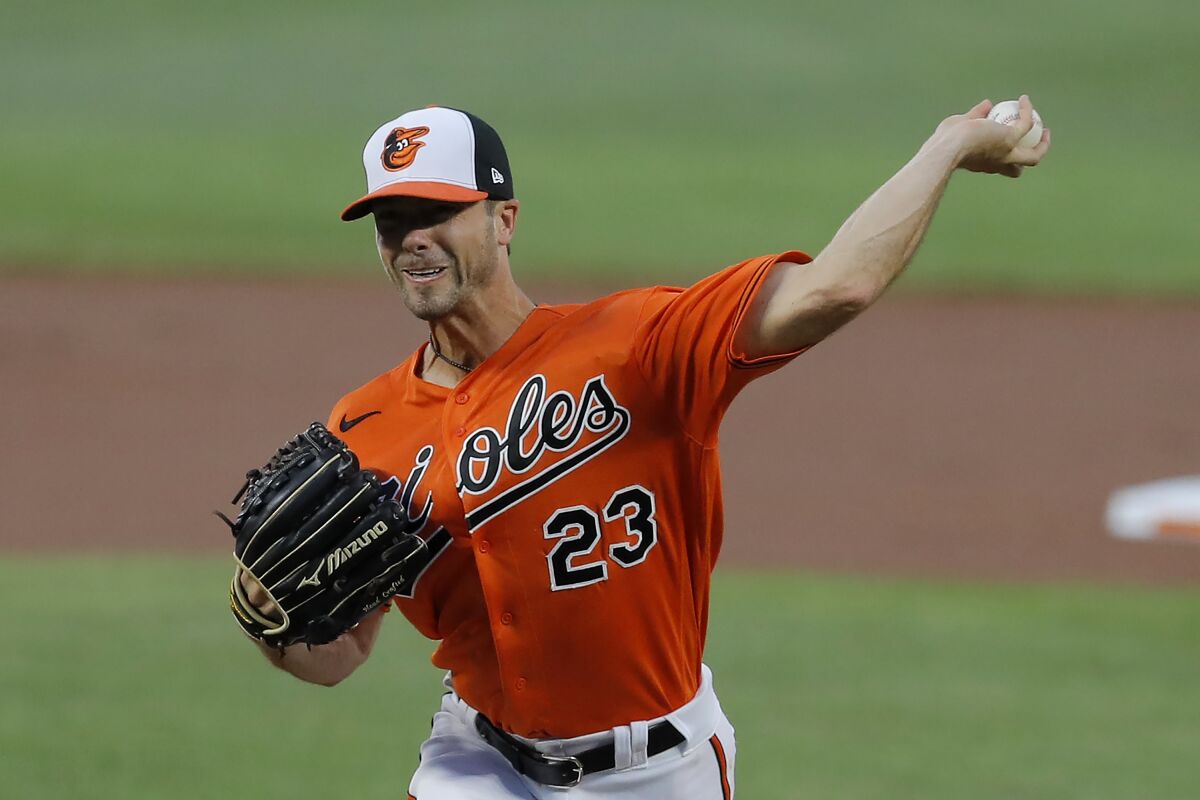 Baltimore Orioles starting pitcher Wade LeBlanc throws a pitch to the Tampa Bay Rays during the first inning of a baseball game, Saturday, Aug. 1, 2020, in Baltimore. (AP Photo/Julio Cortez)