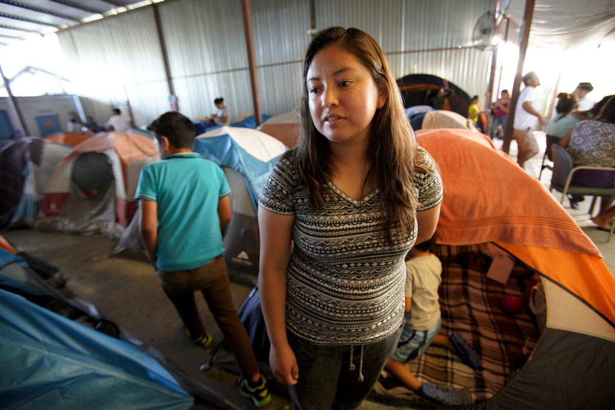 Milsa Garcia along with her son, Fabian Garcia, left their home in Guatemala after her husband threatened to kill her. They waited at the Movimiento Juventud 2000 shelter in Tijuana as dinner was served.