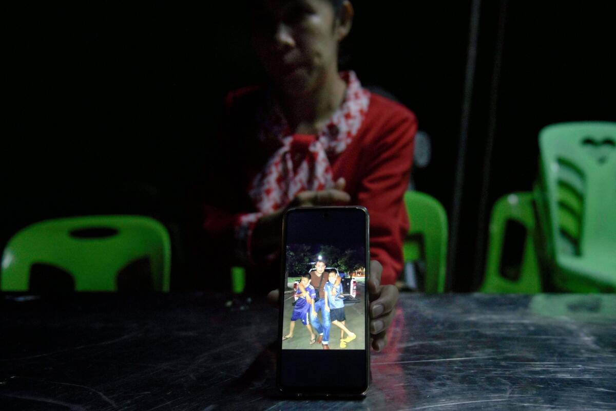A woman shows a picture on her phone.