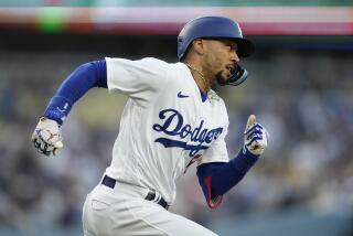 Los Angeles Dodgers' Mookie Betts (50) doubles during the first inning of a baseball game.