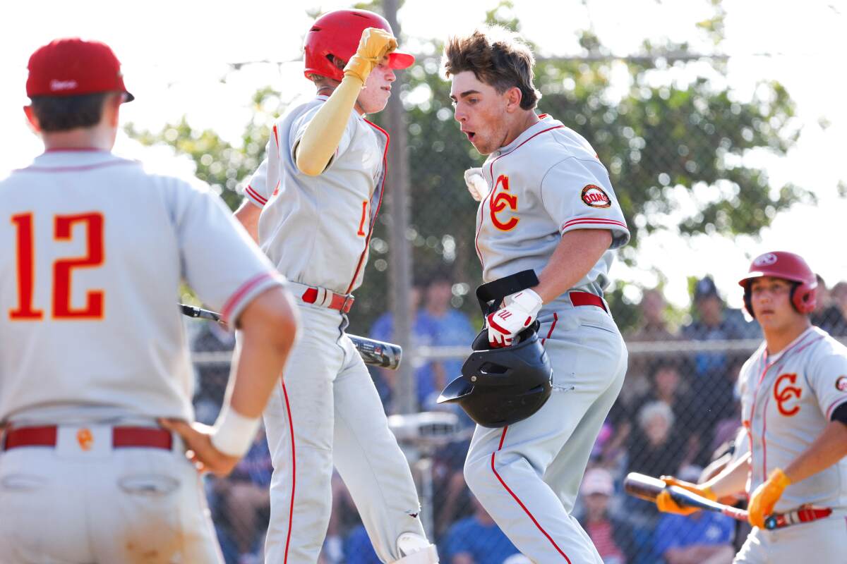 Cathedral Catholic's Joseph Anderson (24), right, and Alex Harrington celebrate Anderson's home run against Rancho Bernardo.