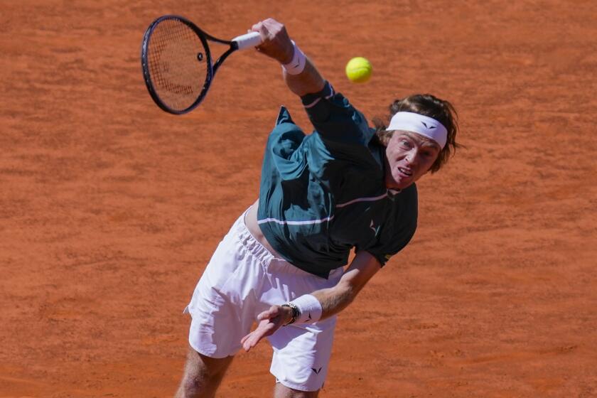 Andrey Rublev, of Russia, serves a ball to Taylor Fritz, of United States, during the Mutua Madrid Open tennis tournament in Madrid, Spain, Friday, May 3, 2024. (AP Photo/Bernat Armangue)
