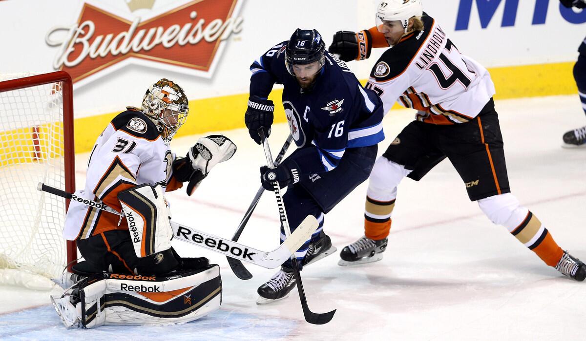 Ducks goaltender Frederik Andersen turns away a shot by Winnipeg's Andrew Ladd in the first period Sunday.