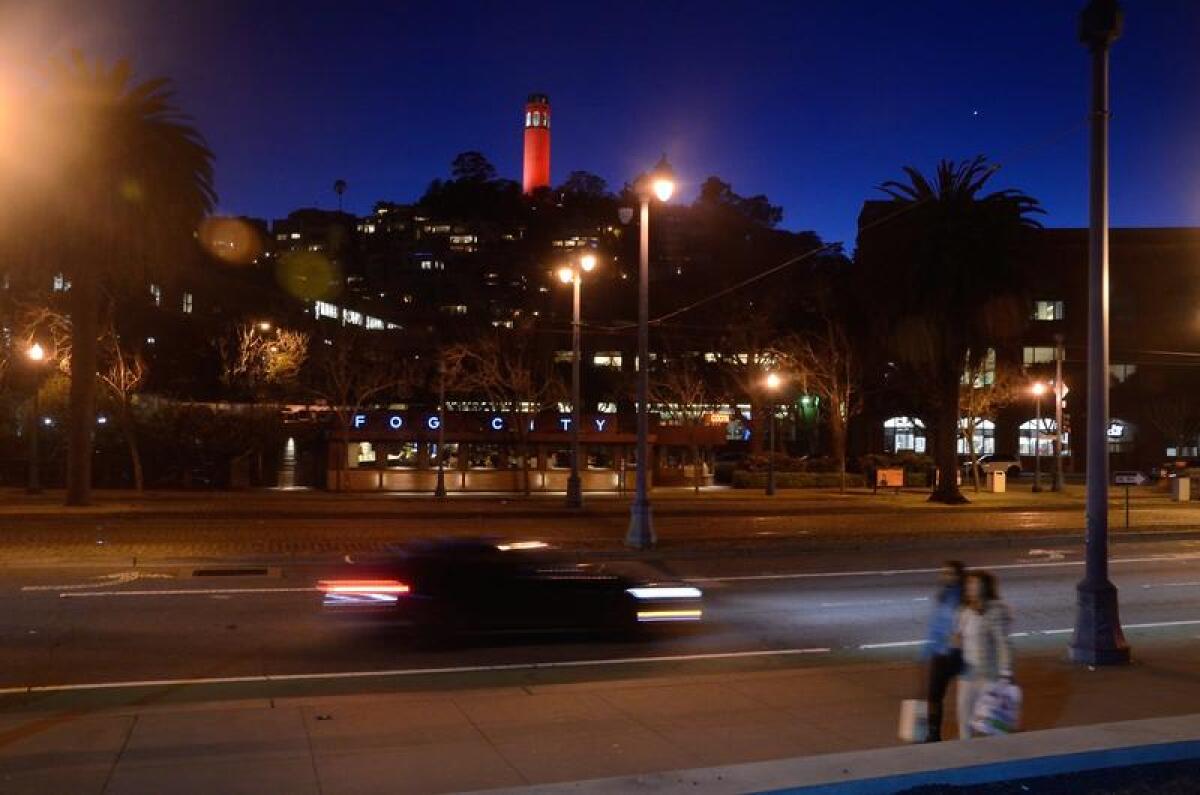 Coit Tower, illuminated in red, March 2017.