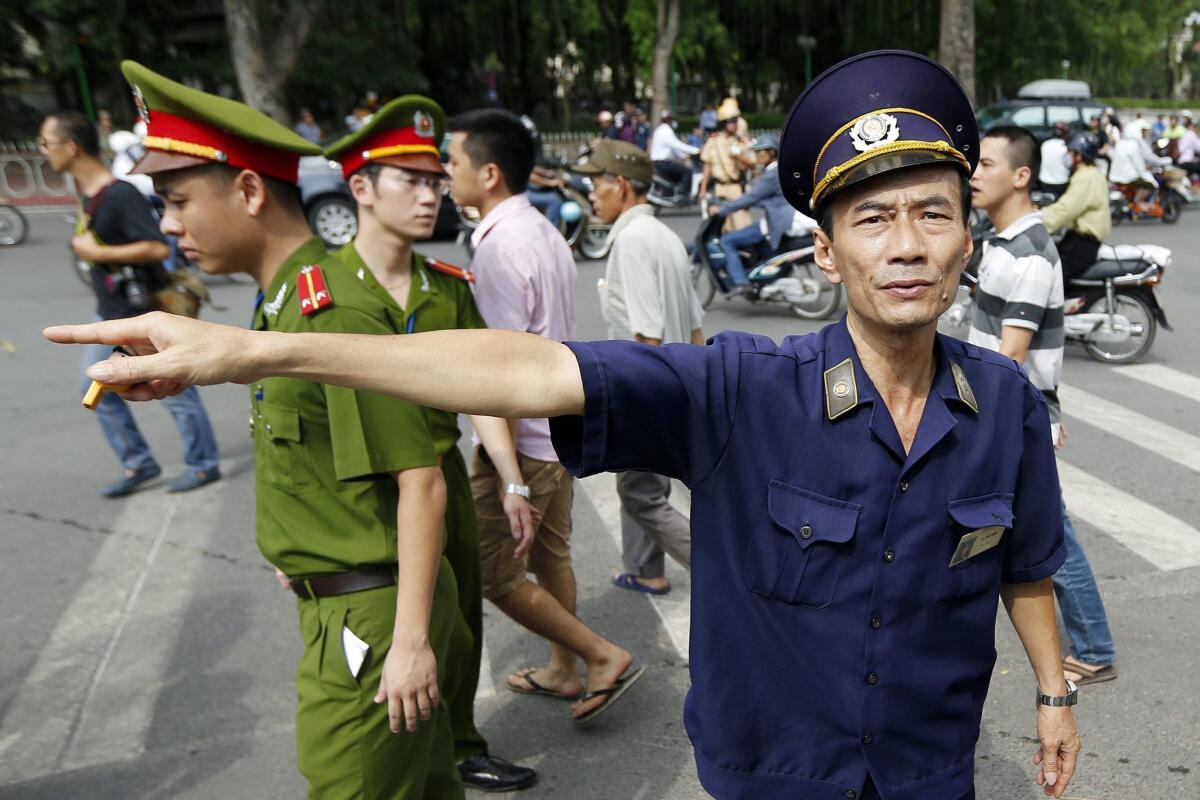 Police try to disperse protesters near the Chinese Embassy in Hanoi, Vietnam, on May 18, amid growing tension over China's move to drill oil in disputed waters of the South China Sea.