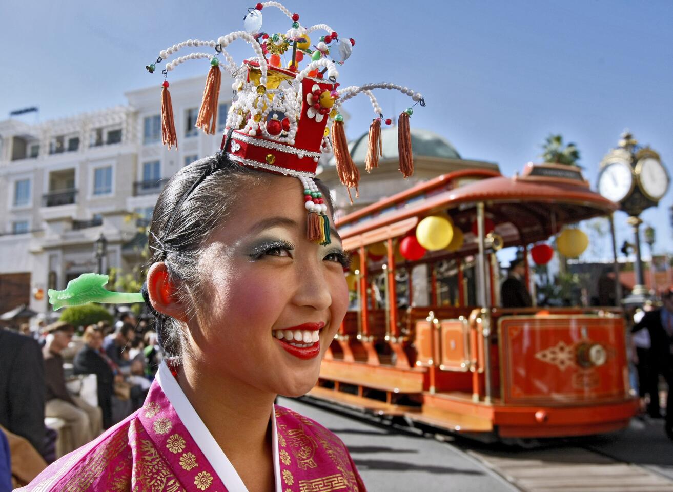 Isabella Kim, 13 of L.A. and from the Jung Im Lee Korean Dance Academy, smiles as the celebrations kicks off during the Americana at Brand's Lunar New Year event in Glendale on Saturday, Feb. 1, 2014. The Americana at Brand kicked off the Year of the Horse with a festival of cultural heritage for the entire family.