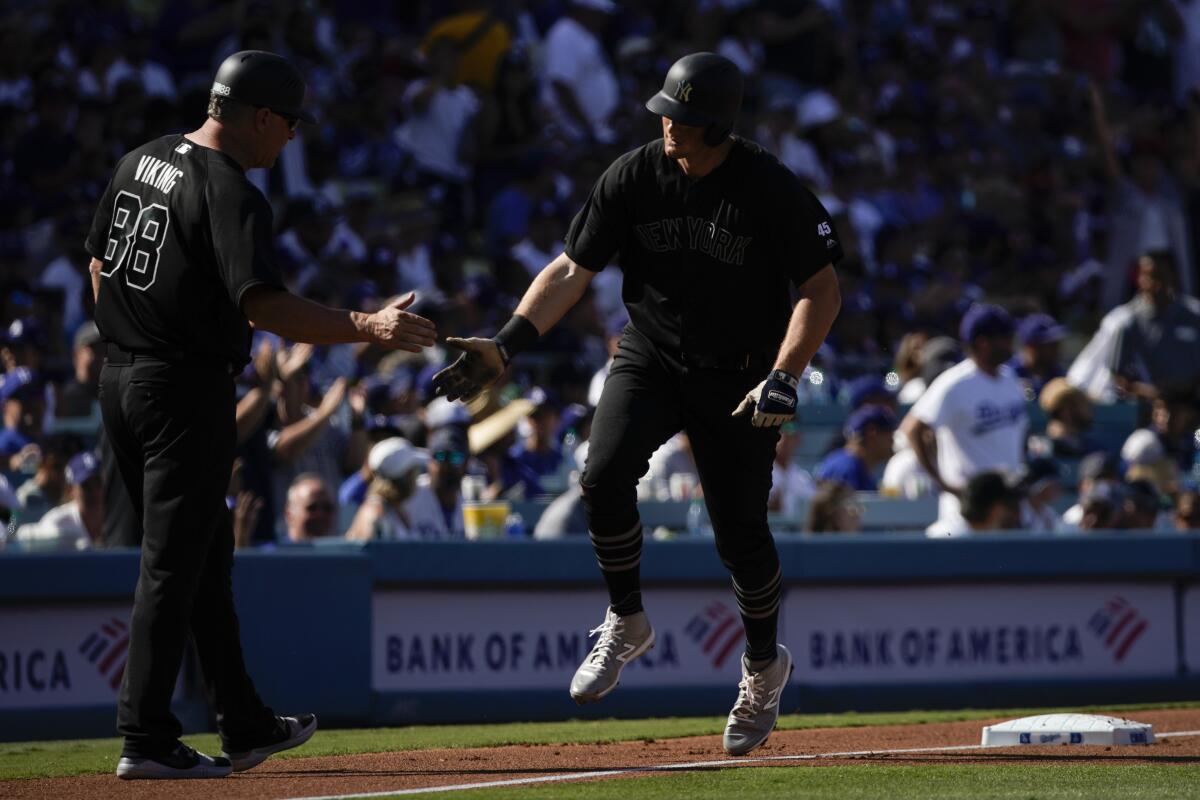 Yankees first baseman DJ LeMahieu is congratulated by third base coach Phil Nevin after hitting a home run.