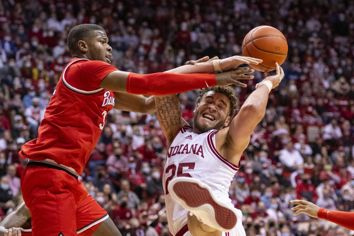 Indiana forward Race Thompson (25) is fouled by Ohio State forward E.J. Liddell, left, while attempting to shoot during the second half of an NCAA college basketball game, Thursday, Jan. 6, 2022, in Bloomington, Ind. (AP Photo/Doug McSchooler)