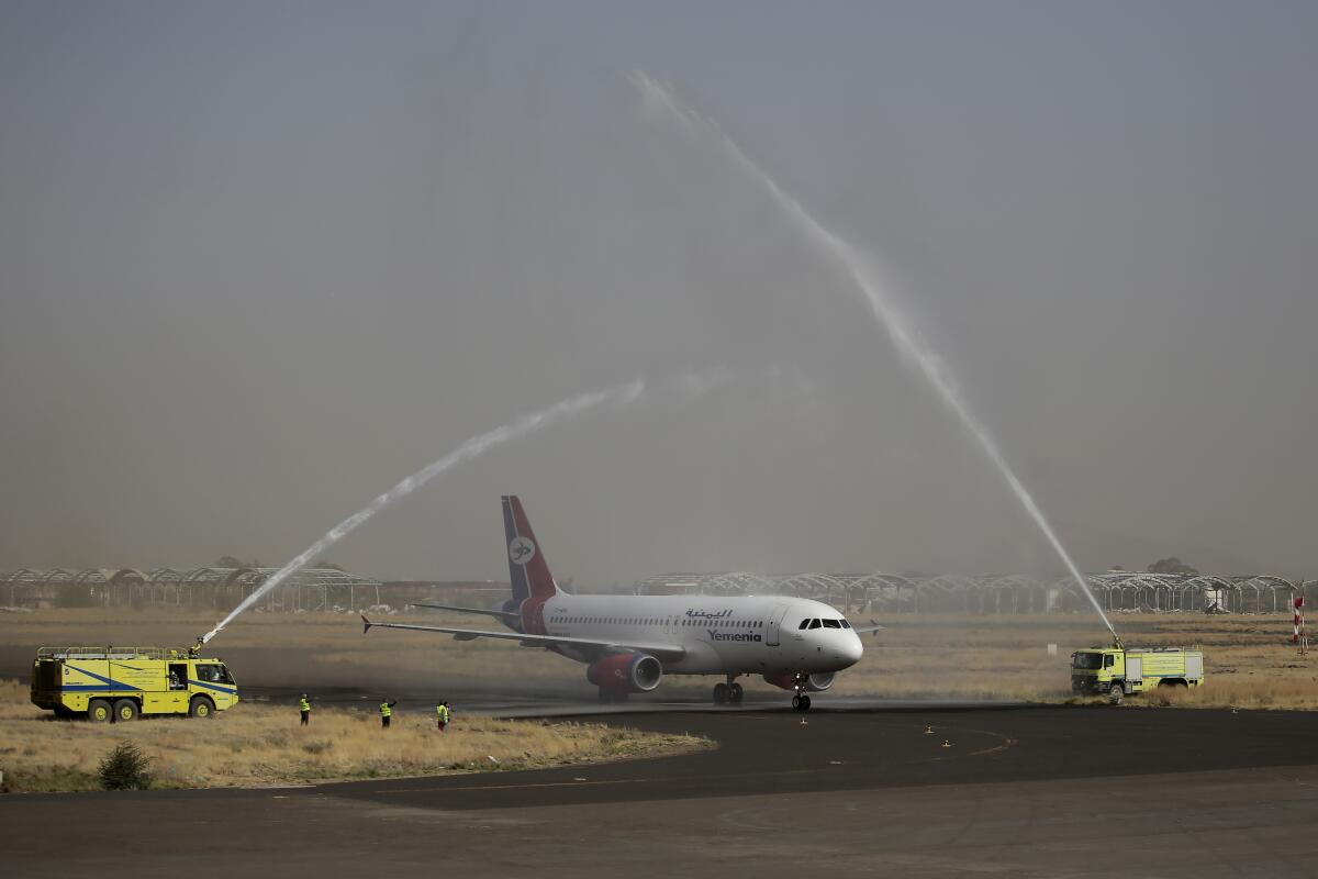 FILE - A Yemen Airways plane, the first commercial flight in six years from Yemen's rebel-held capital is greeted with a water spray salute at the Sanaa international airport, part of a fragile truce in the county's grinding civil war, in Sanaa, Yemen, May, 16, 2022. U.N. Special Envoy for Yemen Hans Grundberg said in a statement June 2, 2022, that Yemen’s warring parties have agreed to renew the nationwide truce for another two months, a rare spot of good news for a country plagued by eight years of war. (AP Photo/Hani Mohammed, File)