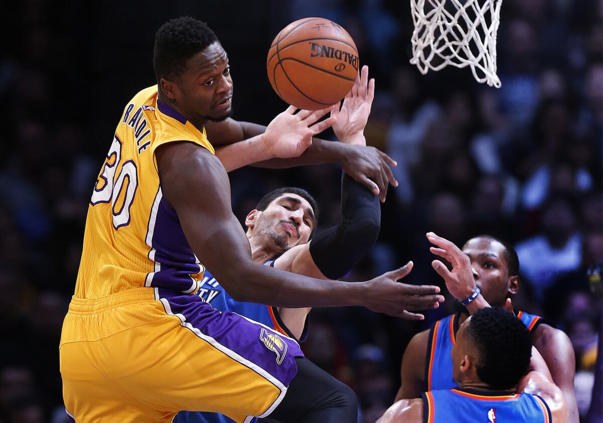 Lakers forward Julius Randle, left, collides with Thunder center Enes Kanter while going for a rebound late in the game.