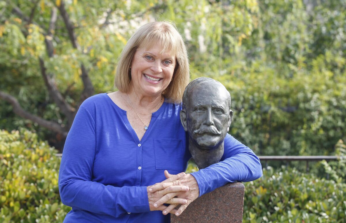 Author Sandra Bonura is shown with the bust of John D. Spreckels at the Spreckels Organ Pavilion at Balboa Park.