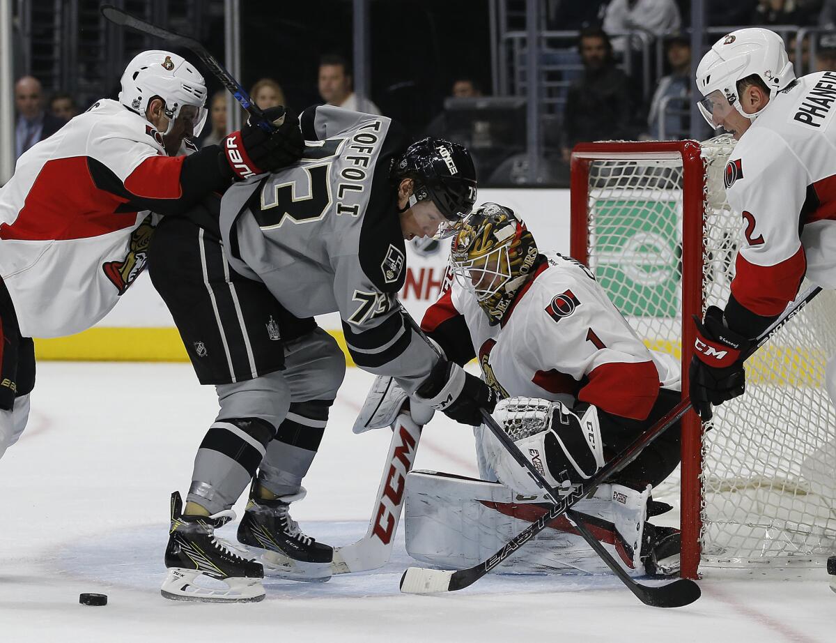 Ottawa goalie Mike Condon (1) rejects a shot by Kings center Tyler Toffoli (73) with the Senators' Dion Phaneuf, right, and Kyle Turris, left, defending during the second period on Dec. 10.