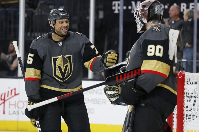 Vegas Golden Knights right wing Ryan Reaves, left, celebrates after scoring against the New Jersey Devils during the third period of an NHL hockey game Tuesday, March 3, 2020, in Las Vegas. (AP Photo/John Locher)