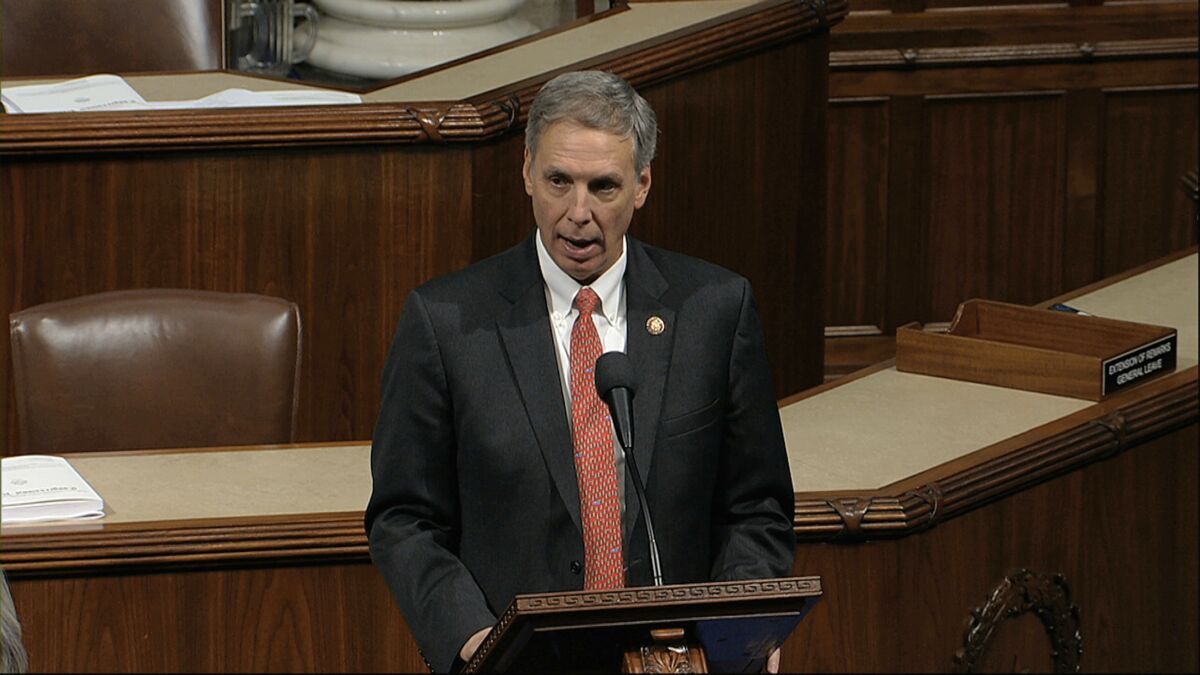 Tom Rice speaks at the dais inside the House chamber in 2019.