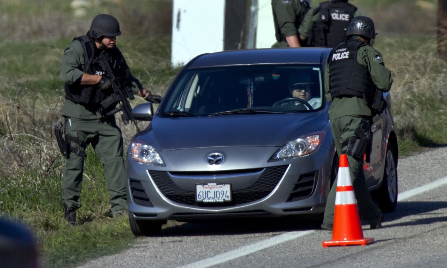 SWAT officers check cars driving south on Highway 38 north of Redlands.