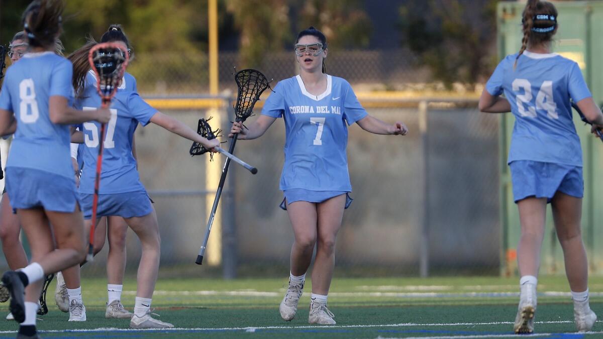Corona del Mar High junior Caroline Brewster (7), shown celebrating a goal on March 14, had five goals Friday as the Sea Kings earned a big win at Beckman.