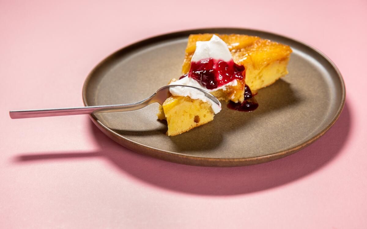 Pineapple-upside down cake with whipped cream and cherry compote.