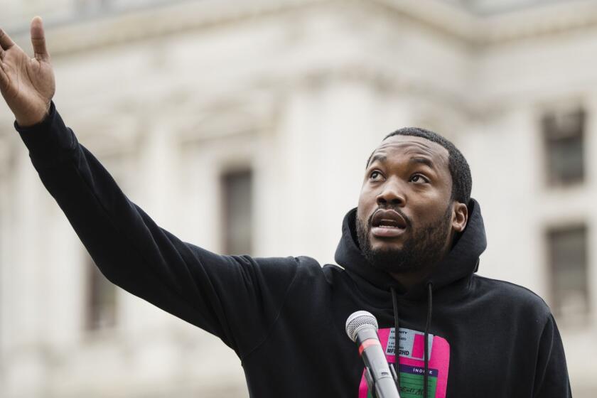 FILE - In this April 2, 2019 file photo, recording artist Meek Mill speaks at a gathering to push for drastic changes to Pennsylvania's probation system, in Philadelphia. Kim Kardashian West, Nipsey Hussle, Common, Kevin Hart and other celebrities are speaking out for prison reform. Mill has become a symbol for reform after a judge in Pennsylvania sentenced him to two to four years in prison for minor violations of his probation in a decade-old gun and drug possession case. (AP Photo/Matt Rourke, File)