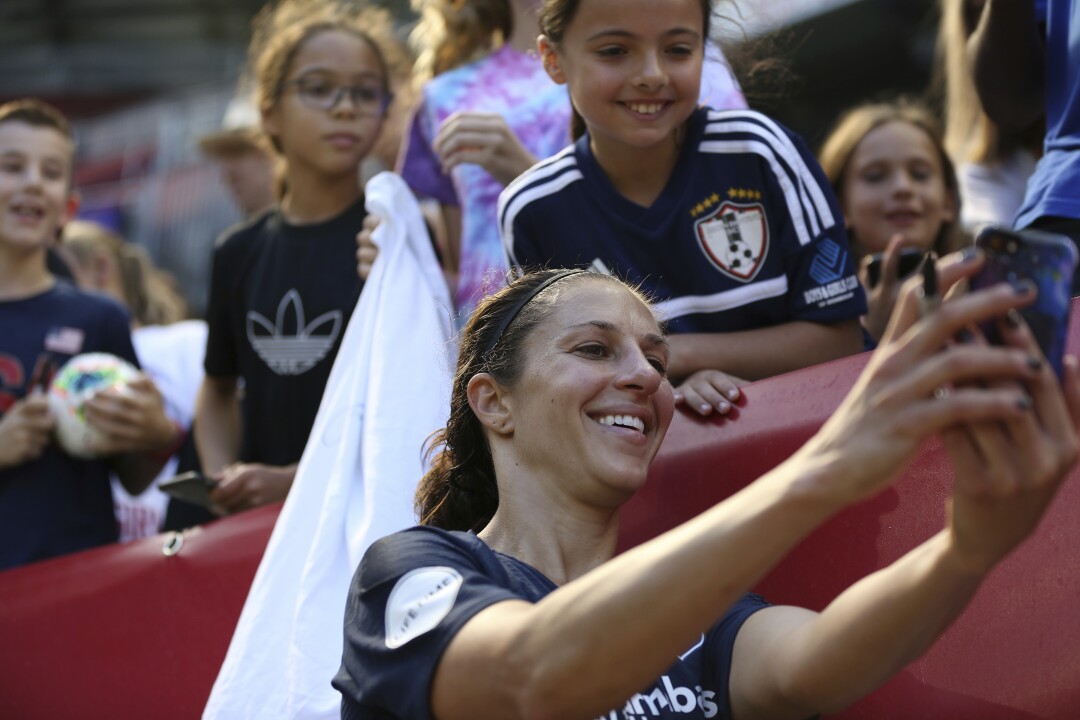 Sky Blue FC midfielder Carli Lloyd takes a selfie with a fan after a 2019 match.