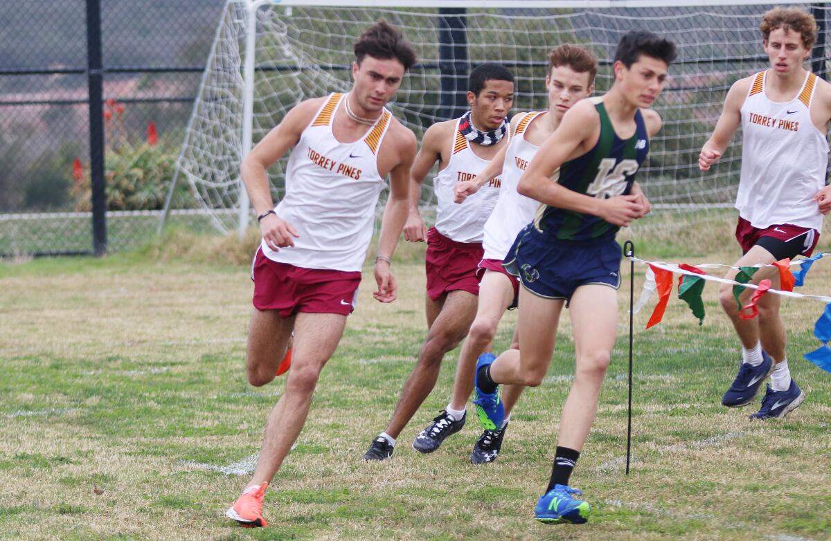 LCC's Jacob Niednagel surrounded by Torrey Pines runners.