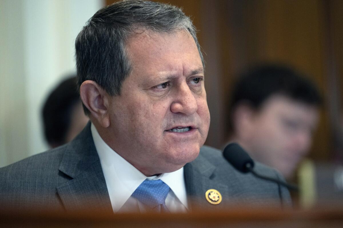 Joseph Morelle pictured from the shoulders up, speaking into a microphone from the front of a hearing room