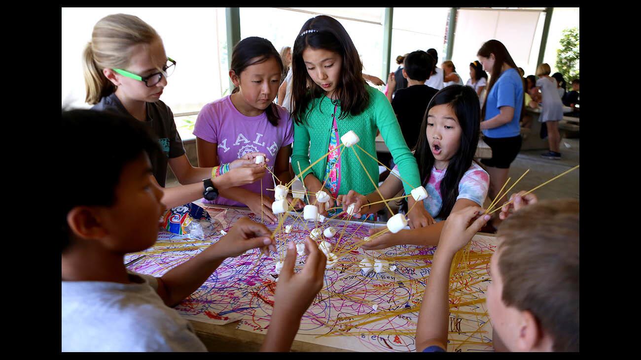 La Canada Unified School District fourth- to sixth-graders build a pasta and marshmallow tower at the Science National Honors Society Camp, at La Canada Elementary School, in La Canada Flintridge on Thursday, June 28, 2018. The towers where then subjected to simulated earthquakes to show which structures were designed with strength.