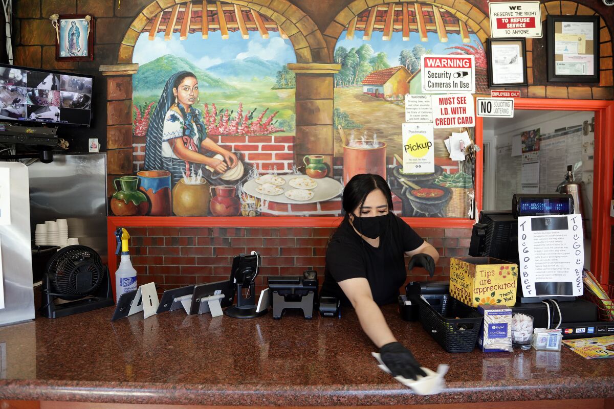 Maricela Moreno wipes down a counter at El Tarasco. She laughs a bit at her money laundering (the literal and legal kind, that is) but adds: “Why not? Just to be safe.”