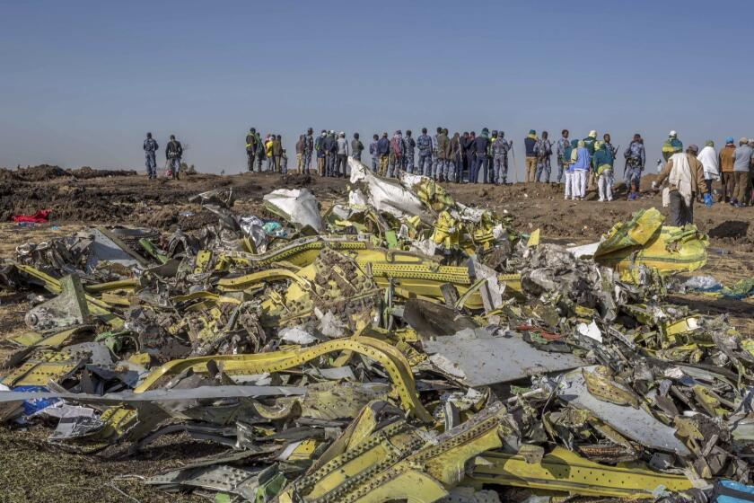 FILE - In this March 11, 2019, file photo, wreckage is piled at the crash scene of an Ethiopian Airlines flight crash near Bishoftu, Ethiopia. Pilot Bernd Kai von Hoesslin pleaded with his bosses for more training on the Boeing Max, just weeks before the Ethiopian Airlines jet crashed, killing everyone on board. (AP Photo/Mulugeta Ayene, File)