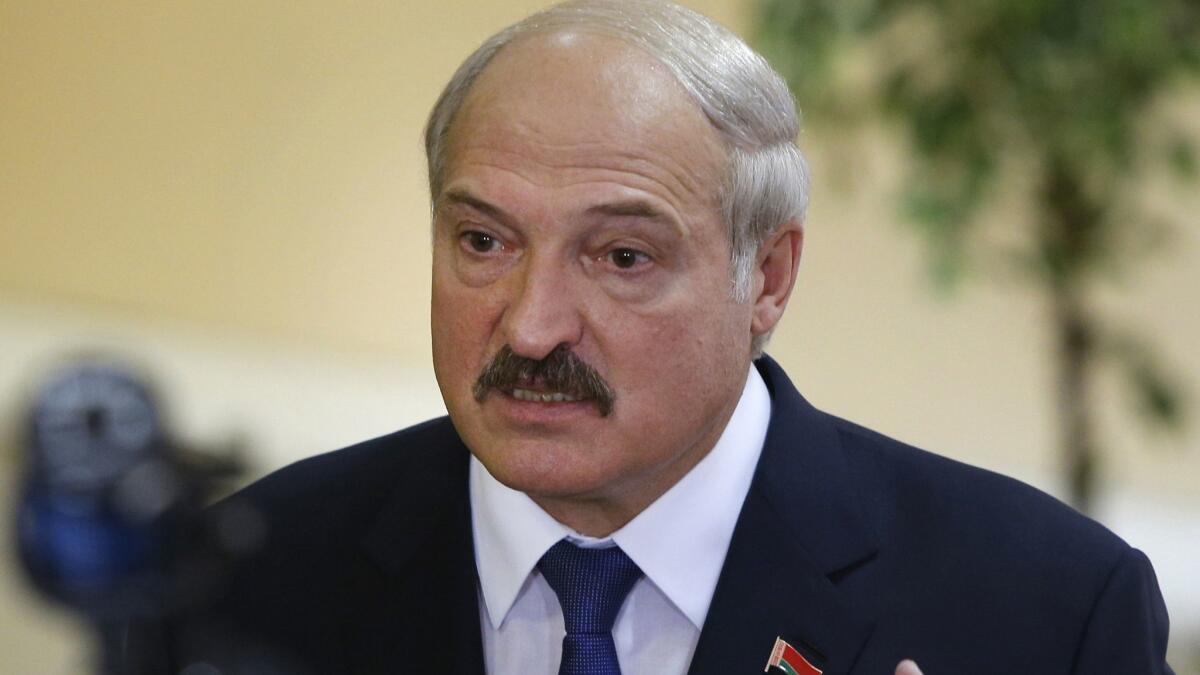 Belarusian President Alexander Lukashenko speaks at a polling station after voting during the 2015 presidential election in Minsk.