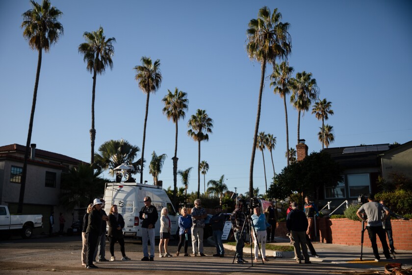 Residents gather Oct. 21 at Newport Avenue and Santa Barbara Street to protest plans to cut down palm trees in the area.