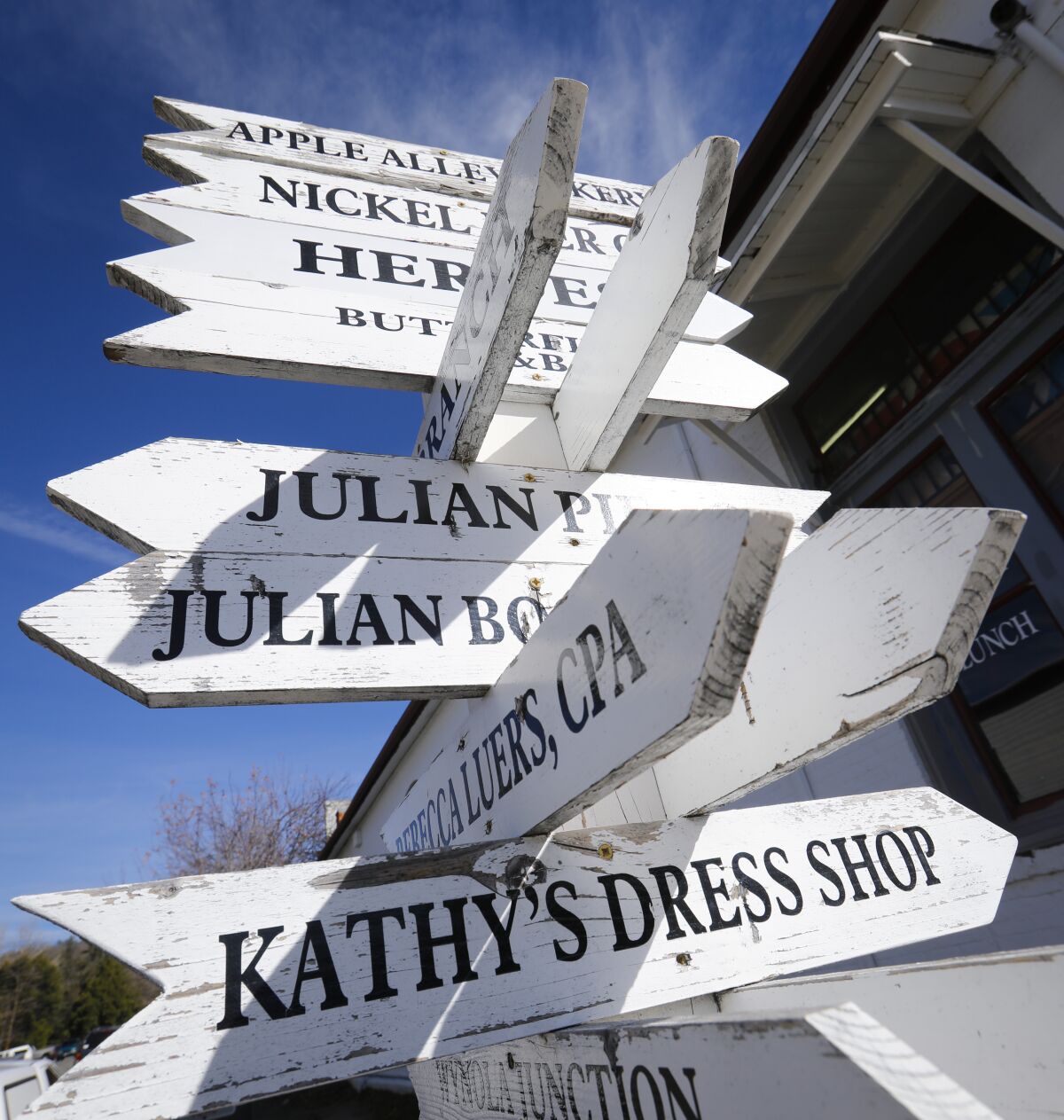 December 17, 2019: Wooden arrows pointing the way to different businesses in Julian area.