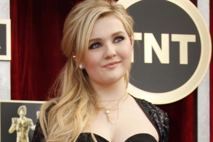 Abigail Breslin of "August: Osage County" arrives for the 20th Annual Screen Actors Guild Awards at the Shrine Auditorium in Los Angeles on Saturday.