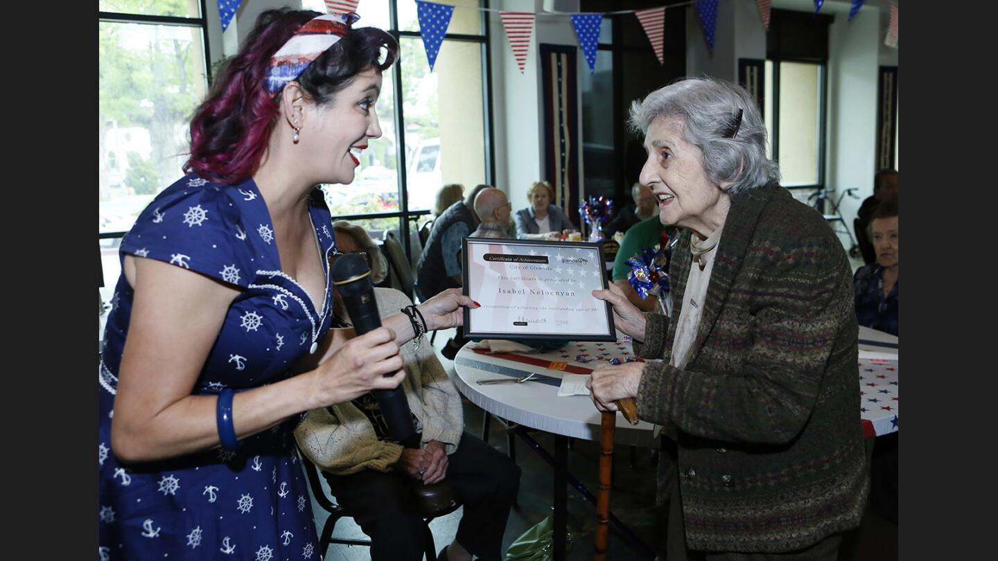 Community Services supervisor Julia Anne Leviant, left, presents 91-year-old Isabel Melconian with a certificate at the annual City of Glendale Community Services & Parks Department's 90-Plus Birthday Celebration at the Adult Recreation Center, in Glendale on Thursday, May 25, 2017.
