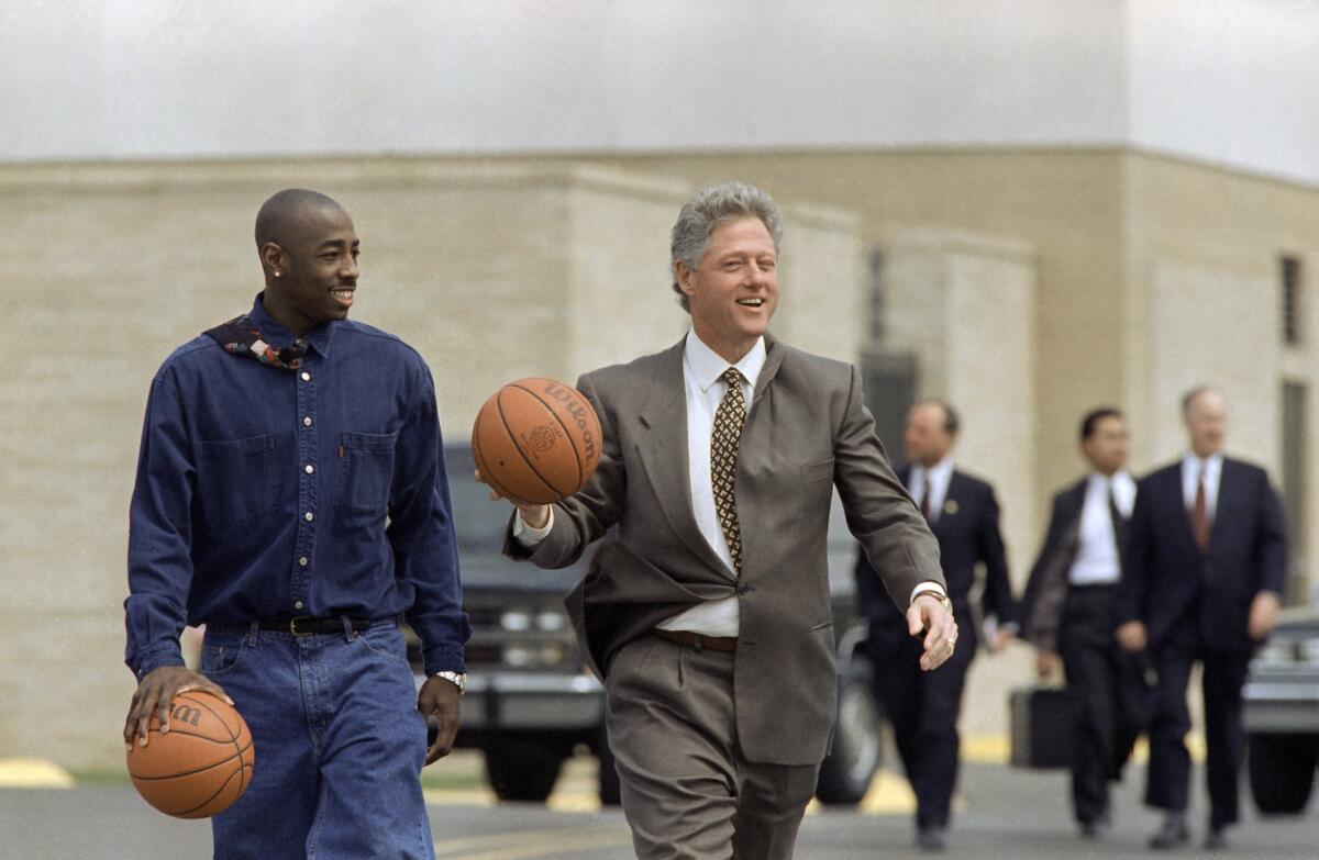 President Bill Clinton walks on the Arkansas State campus with Arthur Agee, a star of the movie  "Hoop Dreams."