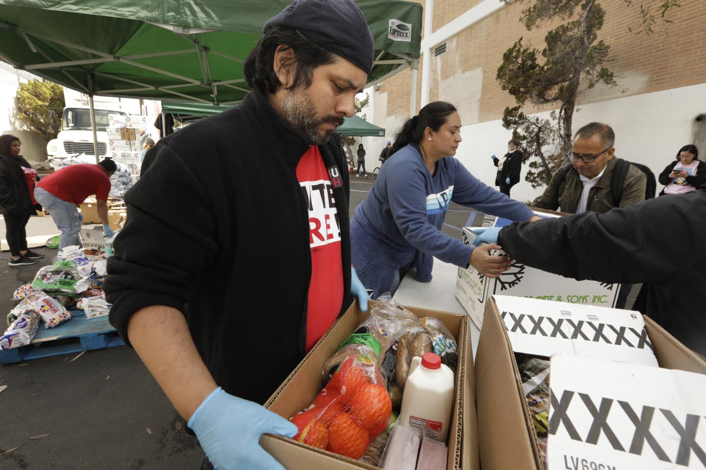 People fill up boxes at the Unite Here Local 11 food bank.