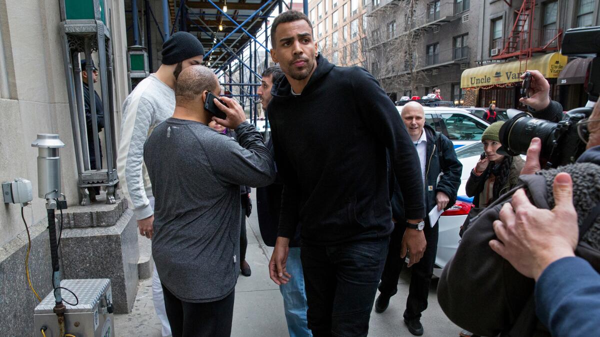 Atlanta Hawks NBA basketball players Thabo Sefolosha, center, and Pero Antic, back left, leave a courthouse in New York on April 8, 2015.